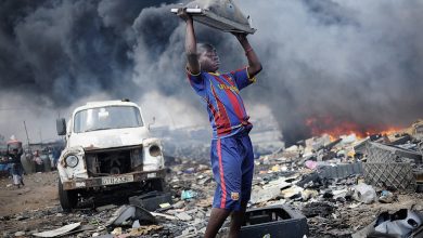 Agbobloshie, Ghana; a young man carrying e-waste.. Picture: CREDIT: KAI LÖFFELBEIN